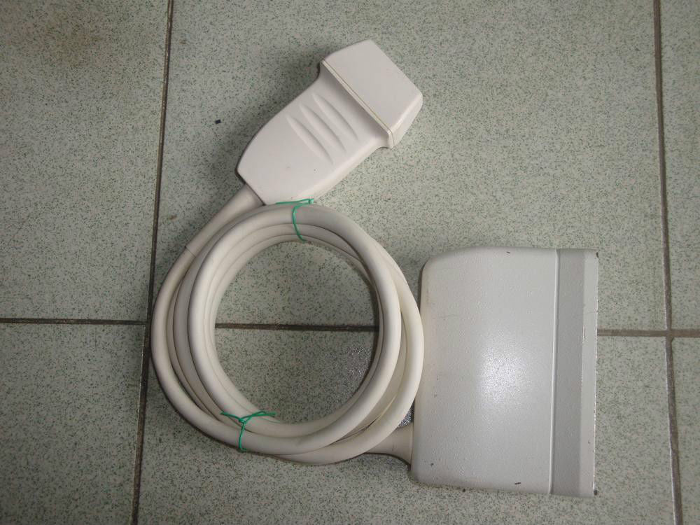 a white electrical device sitting on a tiled floor