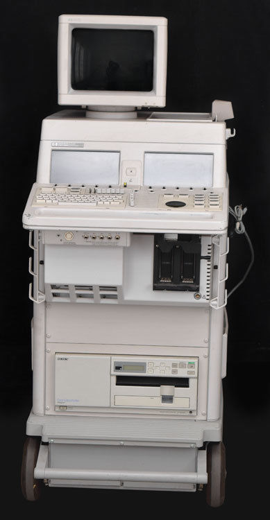 a white computer sitting on top of a cart