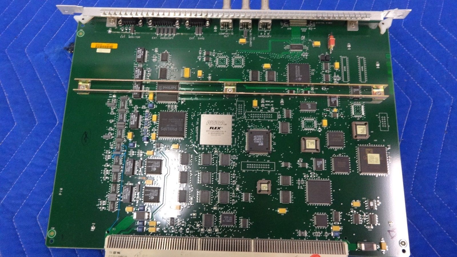 a close up of a computer motherboard on a blue surface