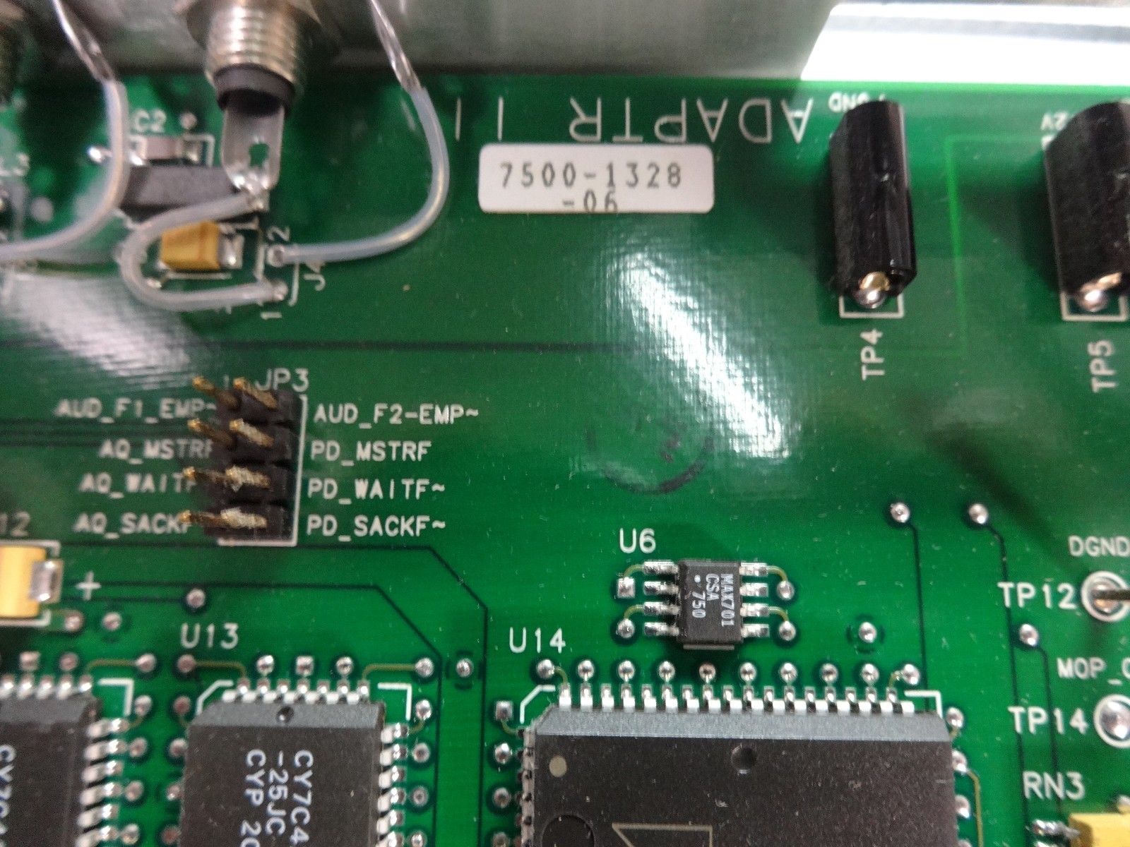 a close up of a green electronic board