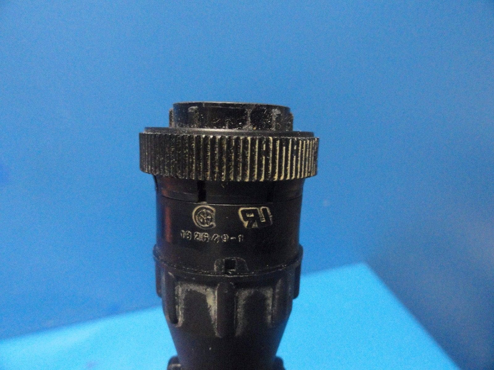 a close up of a probe connector on a blue background