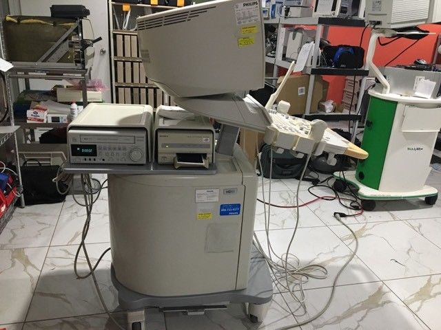 a medical machine sitting on top of a white tile floor