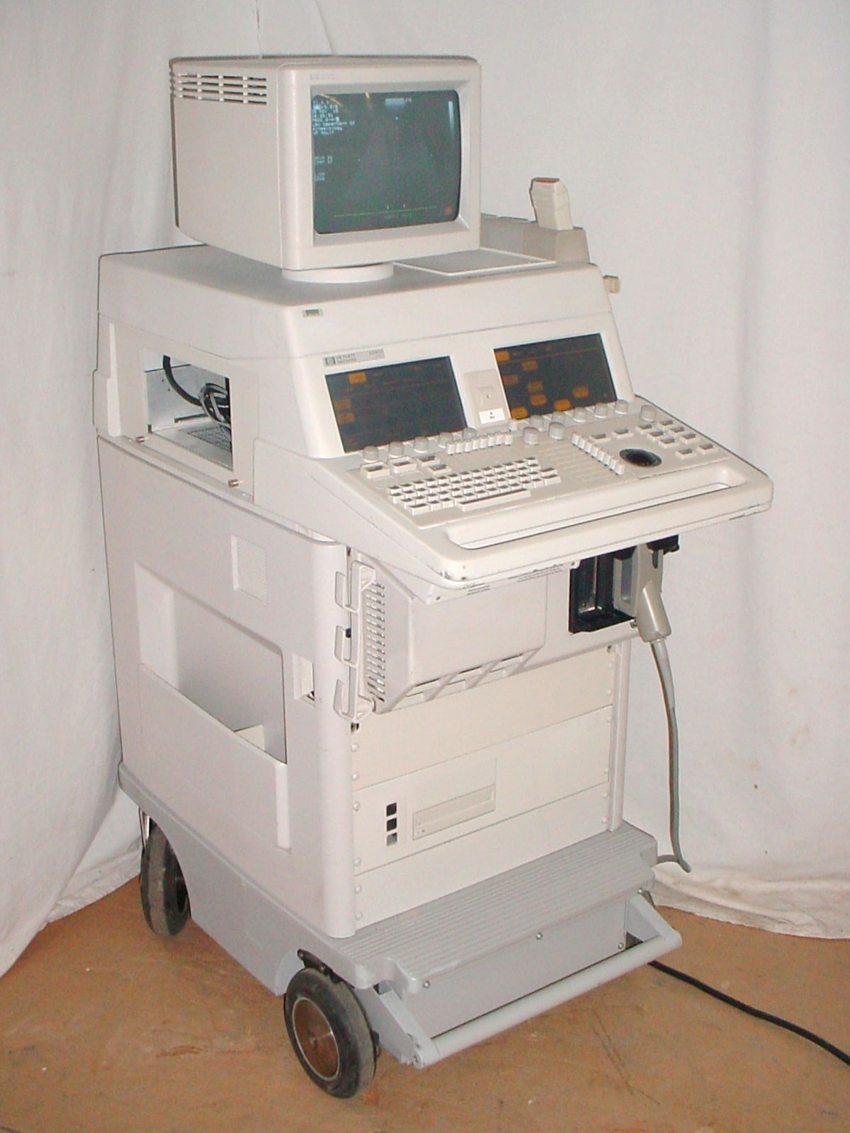 a white computer sitting on top of a cart