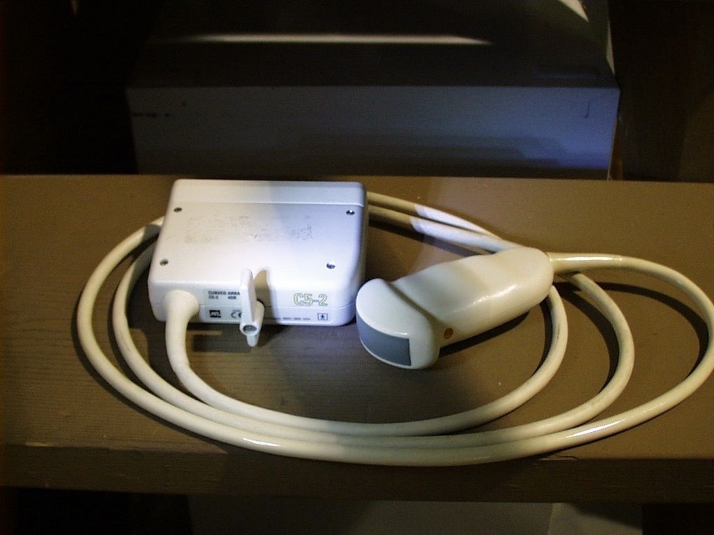 a white cord connected to a device on a table