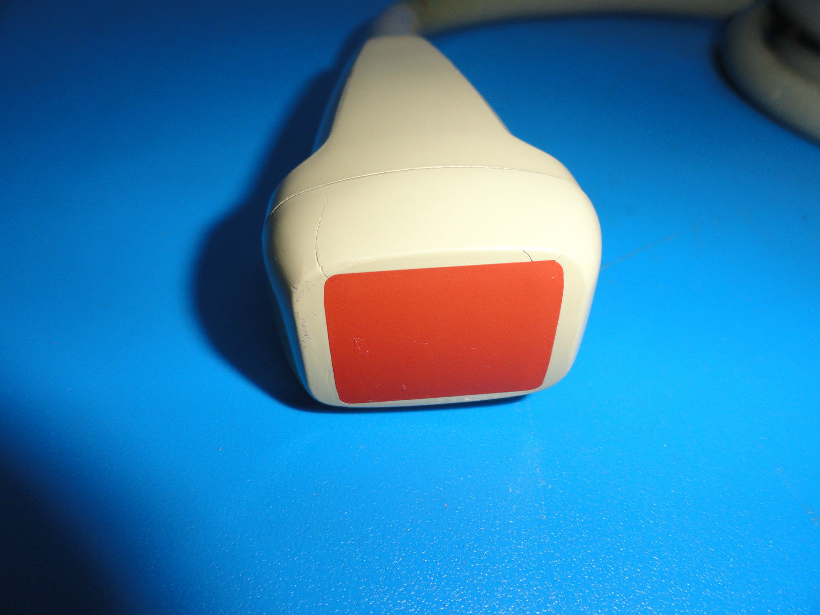a close up of a red and white object on a blue surface
