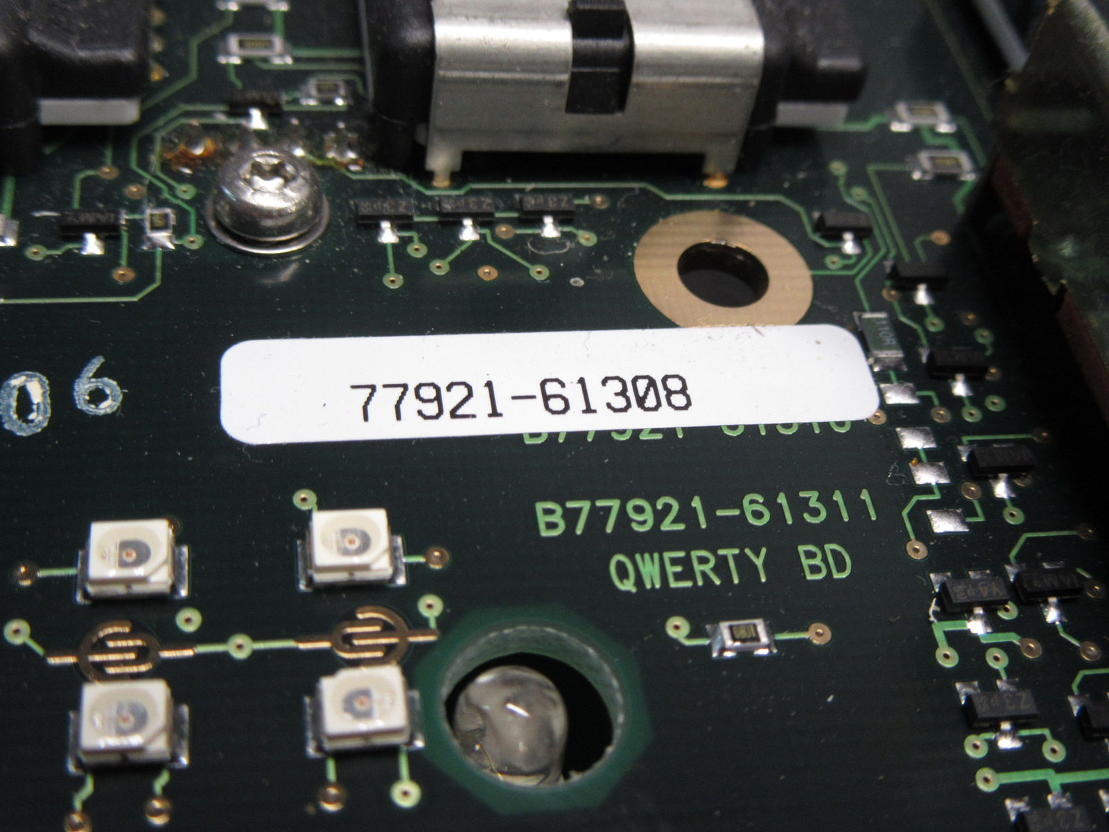 a close up of a circuit board with a screw