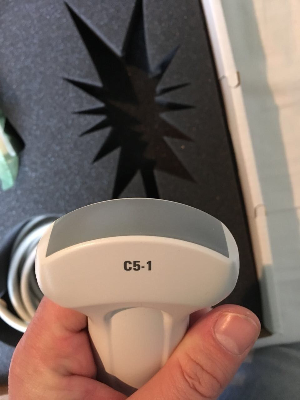 a person holding a white object in their hand