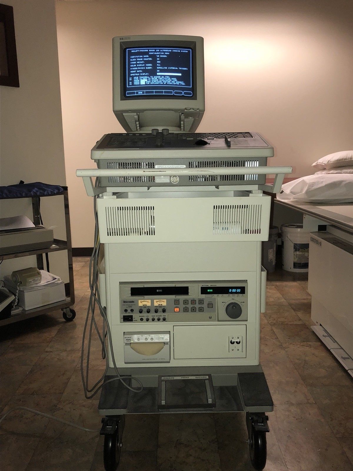 a computer sitting on top of a cart in a room