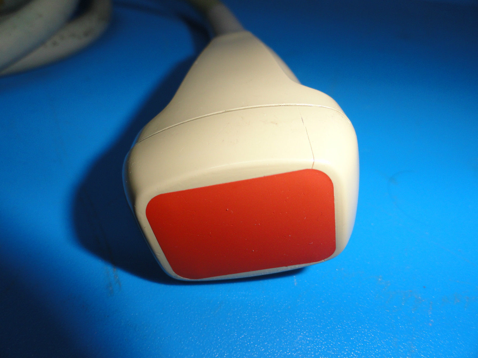 a close up of a red and white object on a blue surface