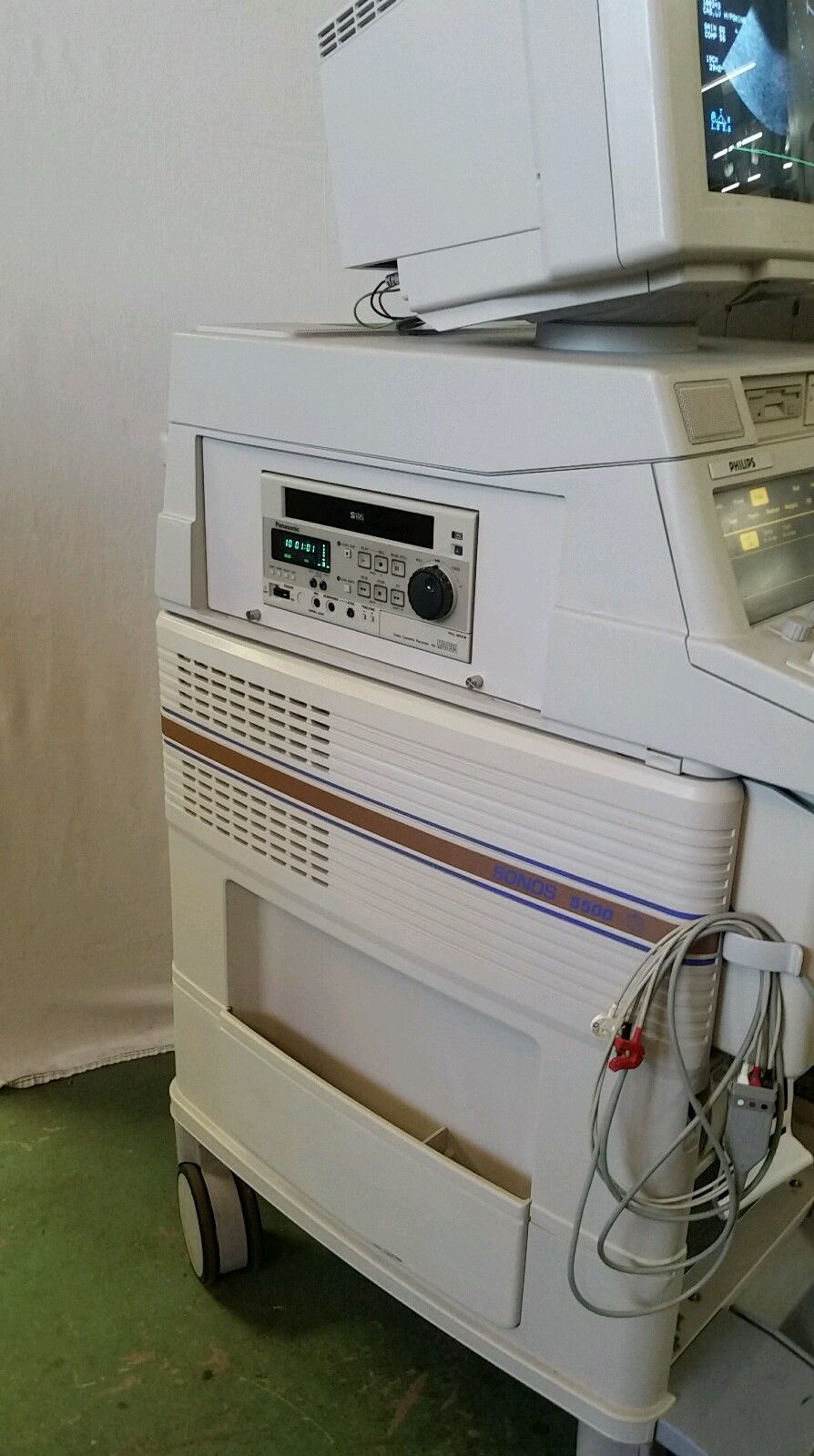 a white machine sitting on top of a green floor